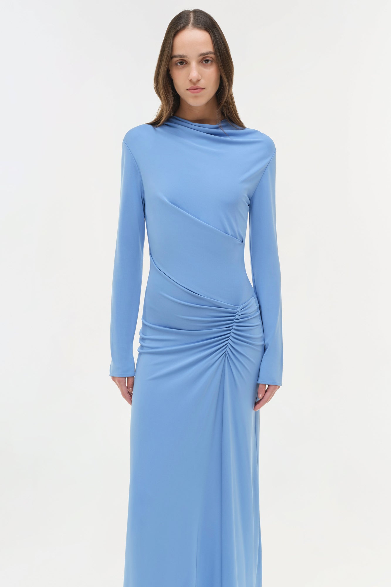 Light blue jersey midi dress with long sleeves, draped bodice, and ruched side detailing.