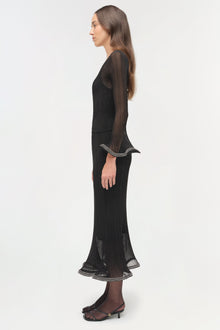 Black metallic plissÃ© long-sleeve top with striped trim detail at cuffs and hem, shown on model in side profile.