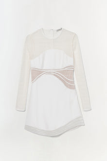 Cream and white long-sleeve dress with mesh panel details at the waist and curved hemline.