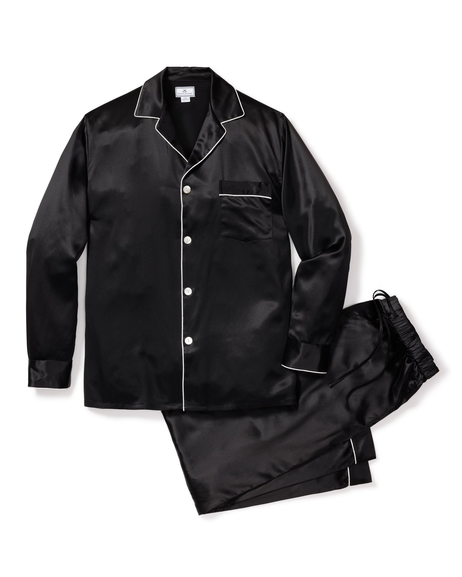 The Mens Silk Pajama Set in Black by Petite Plume is crafted from luxurious mulberry silk and features white piping. This set includes a long-sleeve button-up shirt with a chest pocket and matching elastic-waist pants, combining elegance and comfort effortlessly.