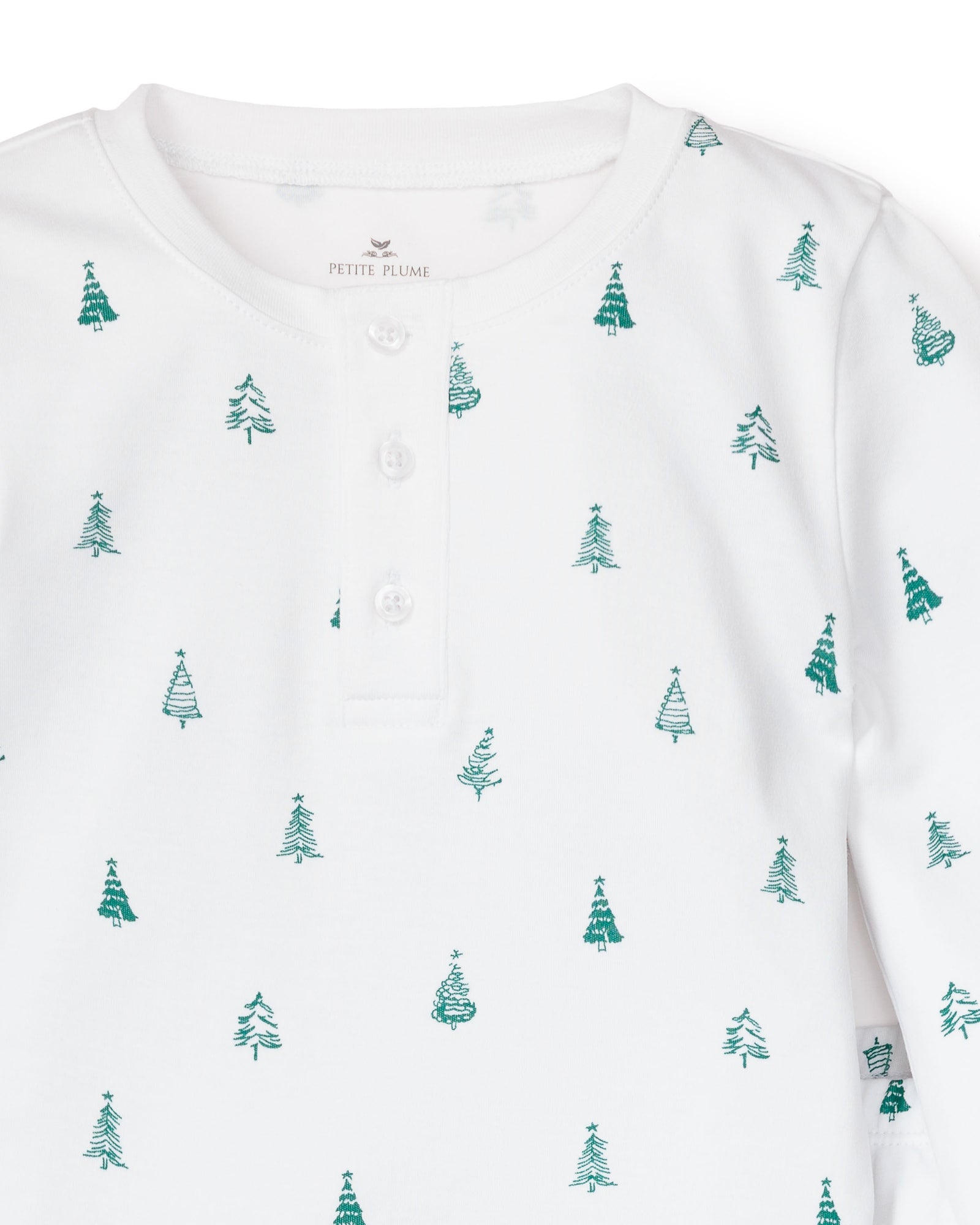 The Kids Pima Snug Fit Pajama Set in Evergreen Trees by Petite Plume is a white henley shirt crafted from soft Pima cotton, featuring small green Christmas trees and three neckline buttons for comfort.