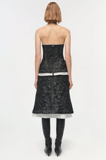Black jacquard midi skirt with white stripe detail, worn with black boots, shown from back view.