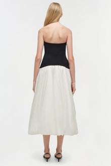 Strapless midi dress with black fitted bodice and cream gathered skirt, shown from back view.