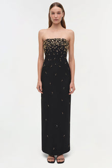 Black strapless gown with gold beaded embellishments concentrated at the bodice, flowing down the length of the dress.
