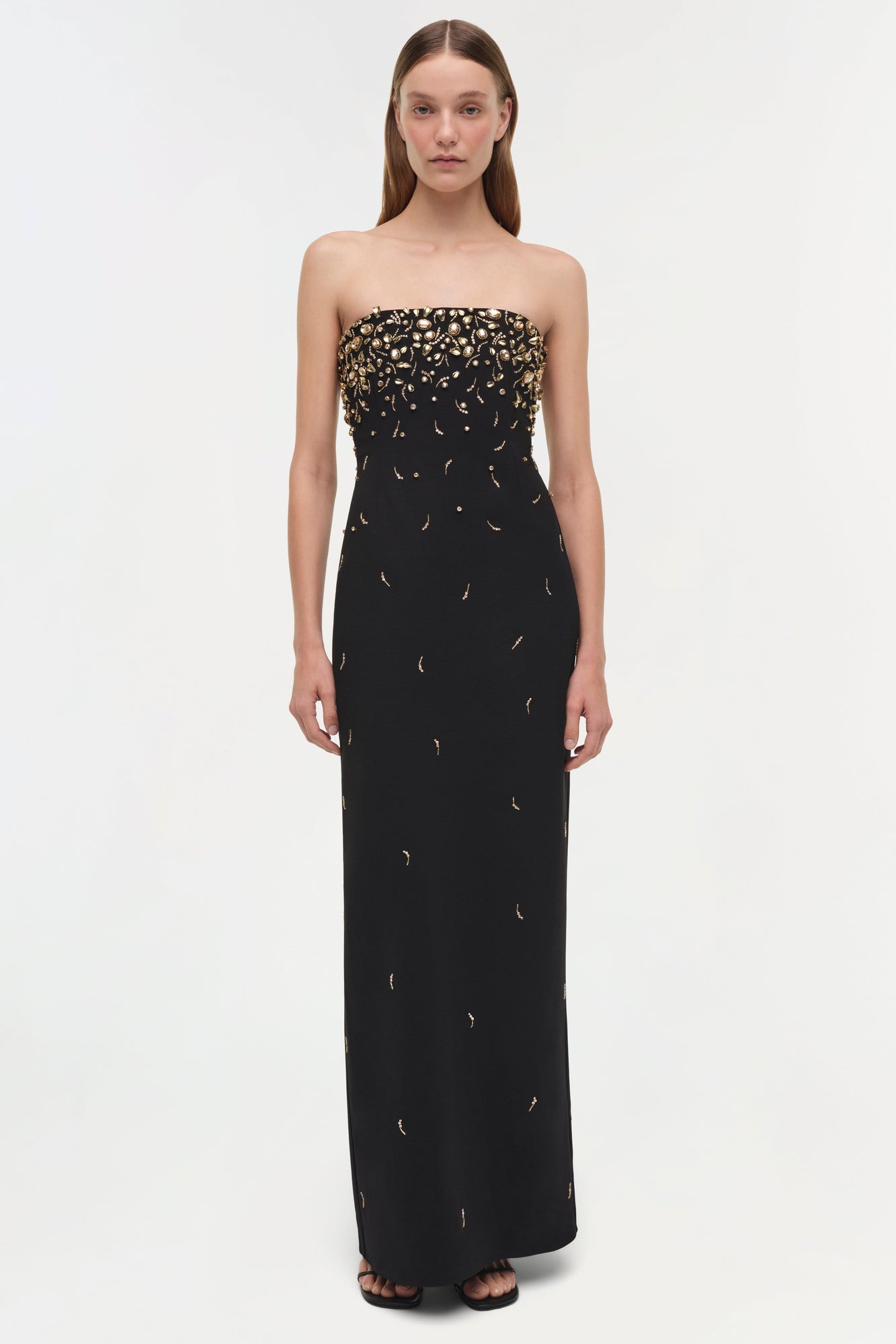 Black strapless gown with gold beading concentrated at the bodice, tapering down the skirt.