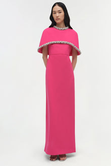 Hot pink floor-length gown with beaded cape overlay and embellished neckline.