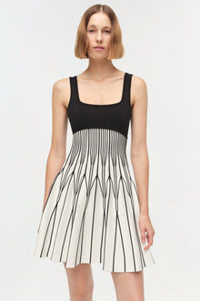 Black and cream knit mini dress with square neckline and vertical striped skirt detail.