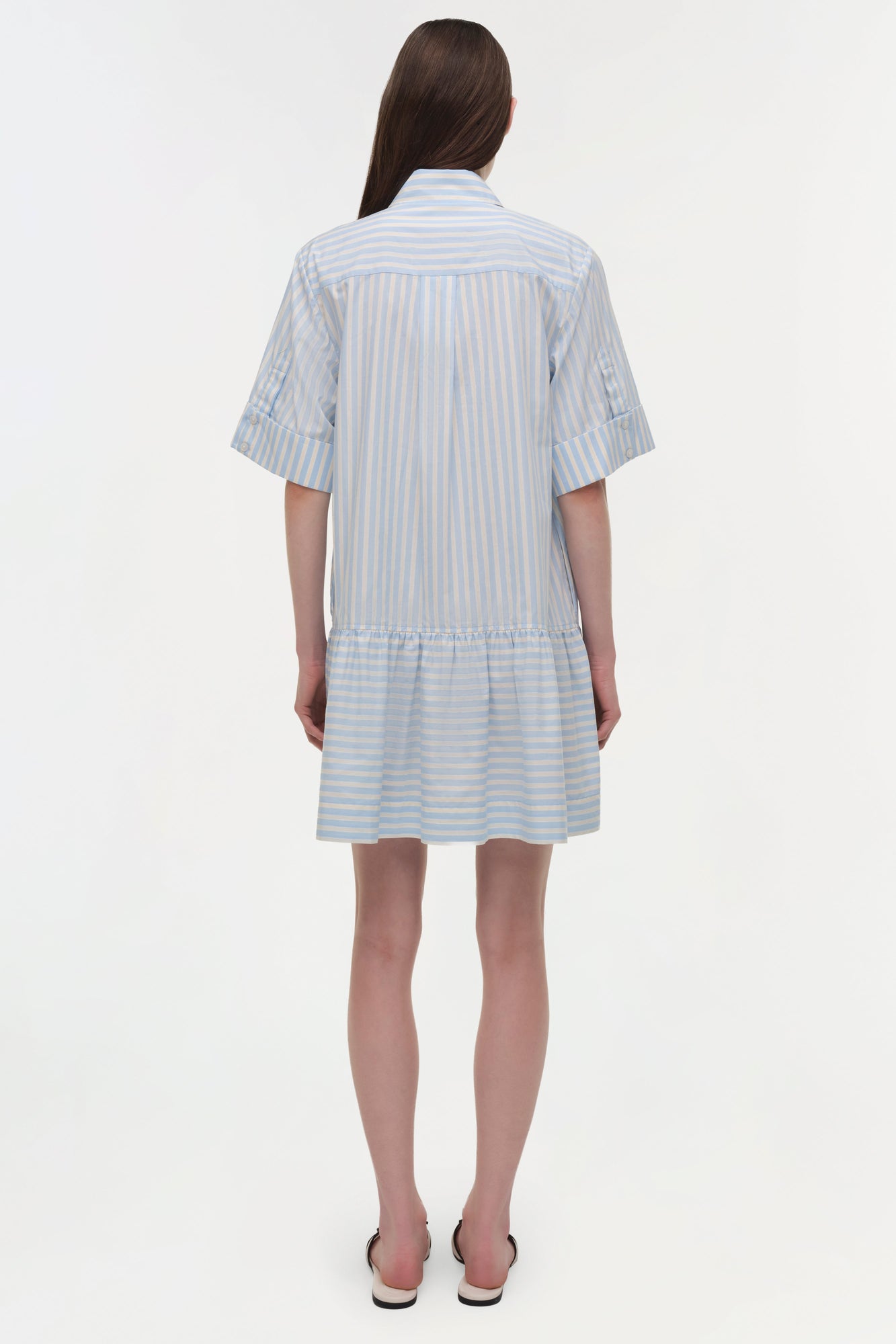 Blue and white striped cotton shirt dress with short sleeves and gathered skirt hem, shown from back.