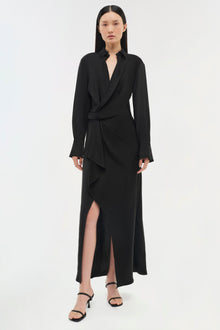 Black wrap dress with long sleeves, collared neckline, and asymmetrical hem with side slit.