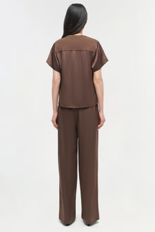 Brown satin t-shirt with short sleeves and matching wide-leg pants, shown on model from back view.