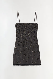 Black mini dress with thin straps and scattered beaded embellishments throughout, featuring a folded neckline and sheer black