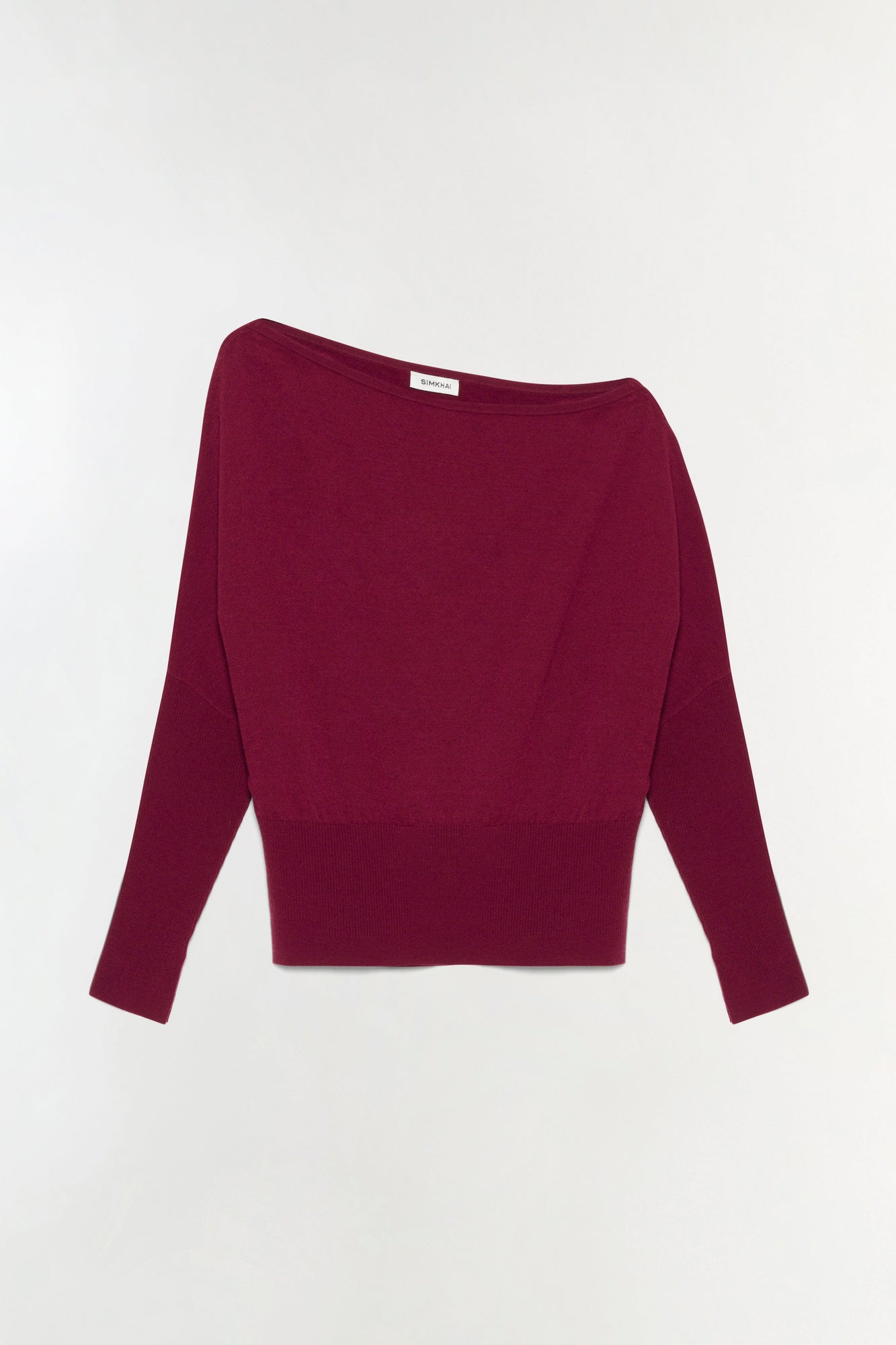 Burgundy off-shoulder sweater with long sleeves and ribbed hem displayed on neutral background.