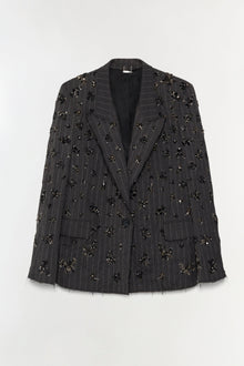 Charcoal pinstriped blazer with scattered black and gold beaded embellishments throughout and frayed edges.
