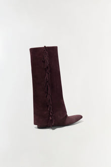 Burgundy suede knee-high boot with fringe trim running down the back seam.