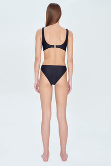 Black bikini bottom with high-cut legs and moderate coverage, shown on model from back view.