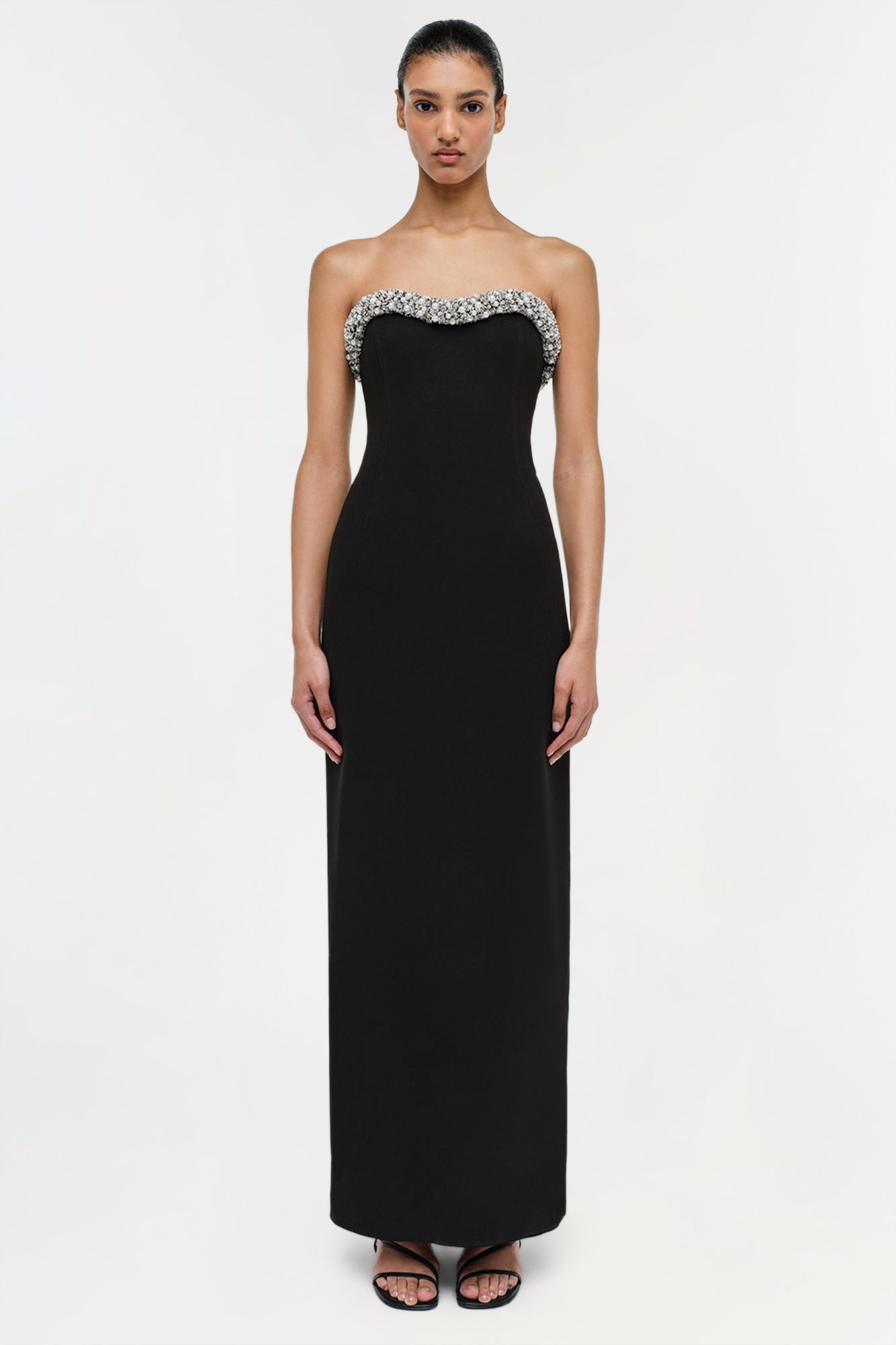 Black strapless floor-length gown with crystal embellishments along the neckline.