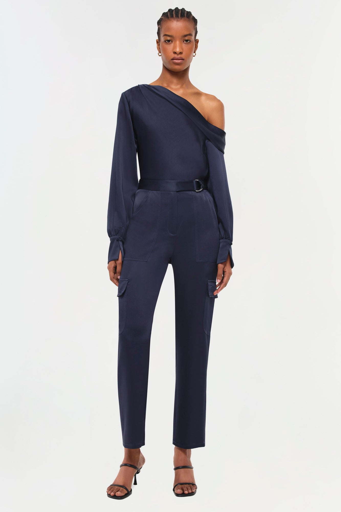 Navy cargo pants with high waist, belt detail, and side pockets.