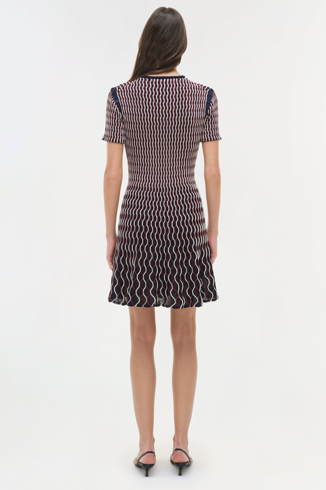 Navy and white wavy striped knit mini dress with short sleeves, shown on model from back view.