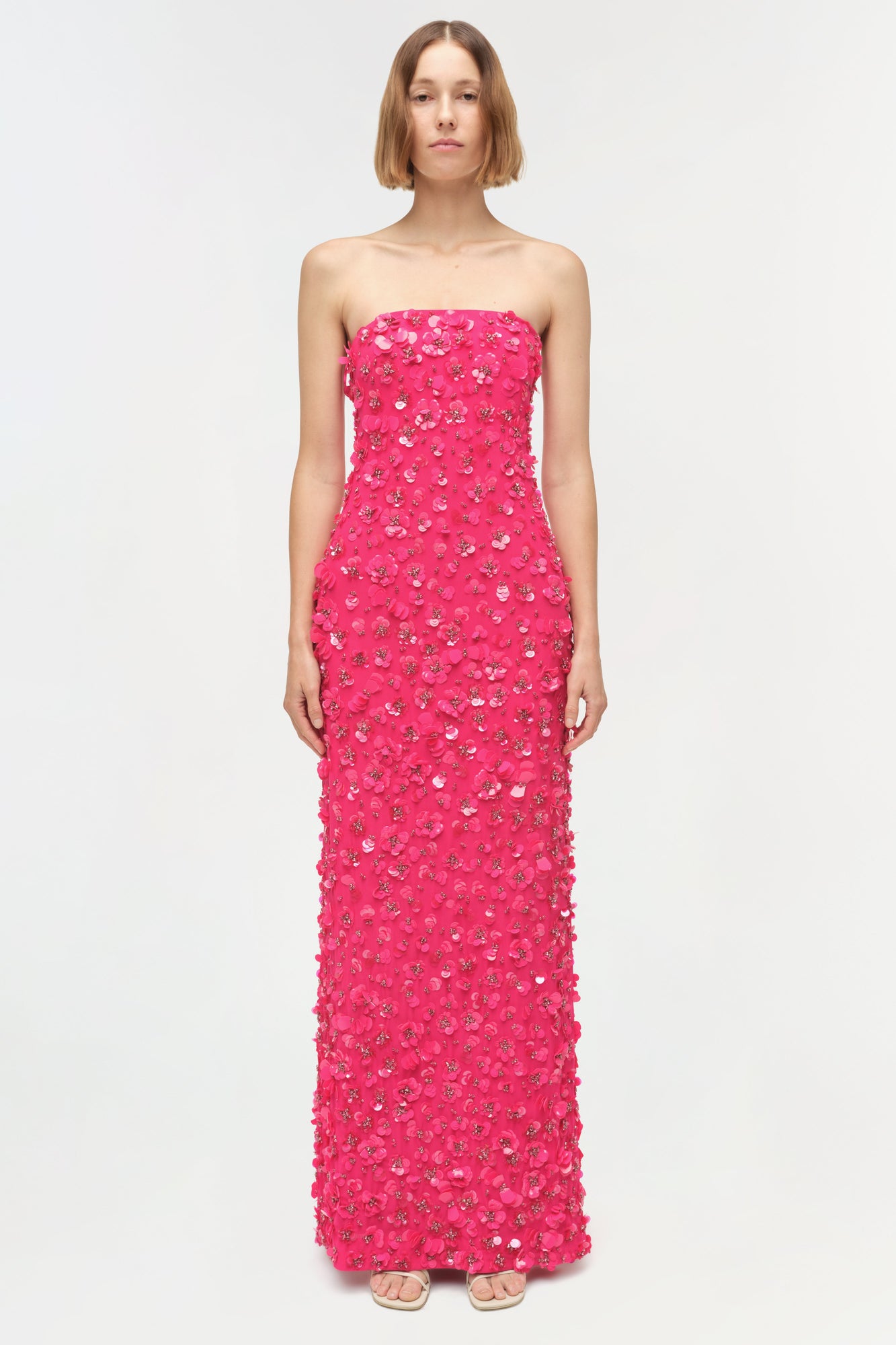 Hot pink strapless floor-length gown with sequin and beaded embellishments throughout.