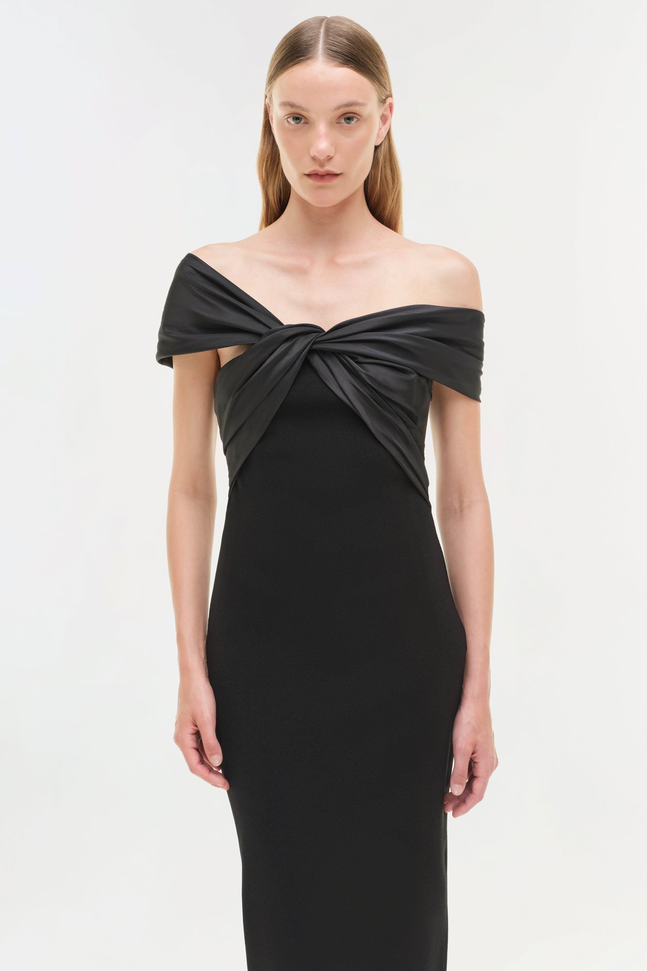 Black off-shoulder midi dress with twisted neckline detail and fitted silhouette.