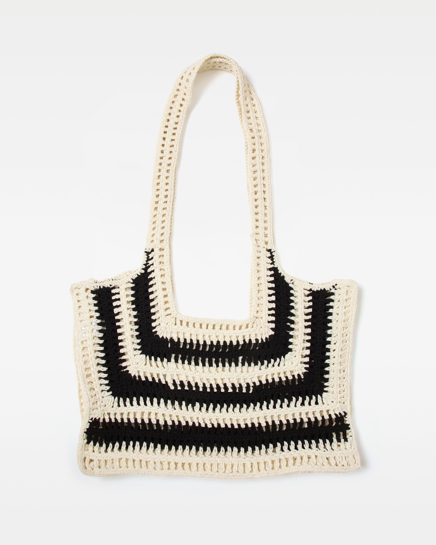 Flat lay of the black and white Caylin Crochet Tote.