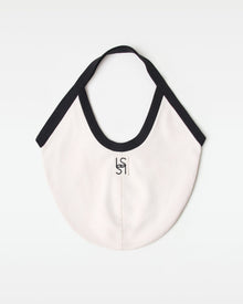 Off-model back view of the black and cream Bronte Canvas Bag showing a L*SPACE logo.