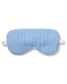 The Adults Sleep Mask in French Blue Seersucker by Petite Plume, featuring a blue and white stripe design with an elastic strap, makes the perfect gift. Pair it with matching eye masks for a thoughtful present.