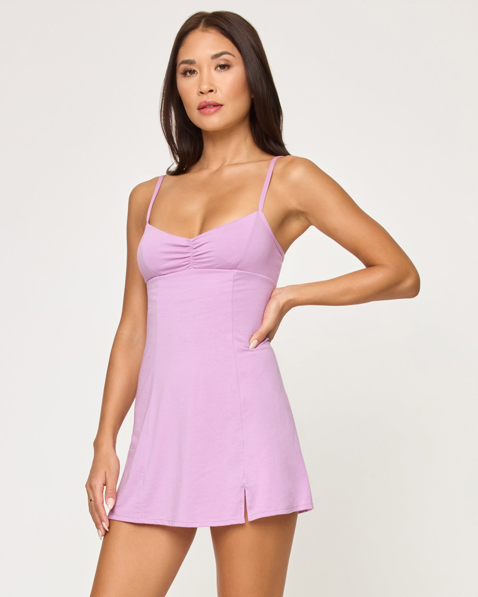 Close-up front studio view of model wearing the Kelsey Dress in mauve, hand on hip.