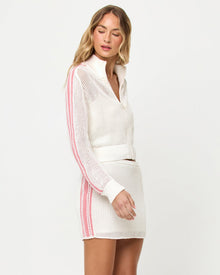 Side profile studio view of the Heart Stopper Sweater and Skirt in cream, a cream crochet-knit zip-front cropped sweater paired with a cream crochet mini skirt, pink stripe trim along the side.