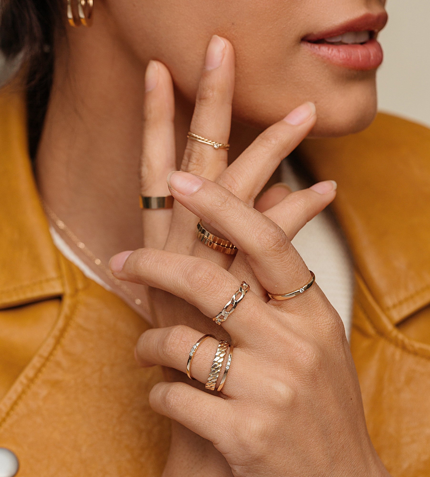 Diamond Tension Ring Lifestyle Model. Close up of woman's hand with various gold and diamond rings