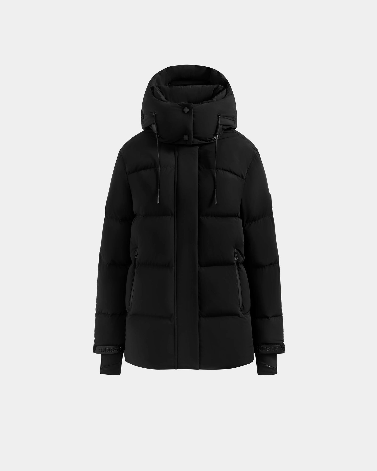 The Rudsak ALESSANDRA S-M - L125551 Black is a black cropped puffer jacket with a hood, front zipper, snap buttons, and two side pockets, displayed on a plain light gray background—a cold-weather essential.