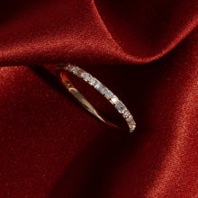 Flatlay Model. Diamond eternity ring on red velvet background