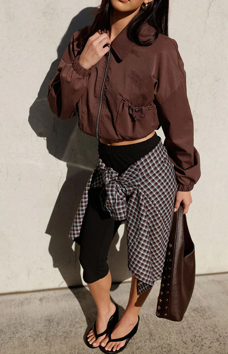 Chocolate cropped bomber jacket with a collar, full zip, and side drawstring hem detail