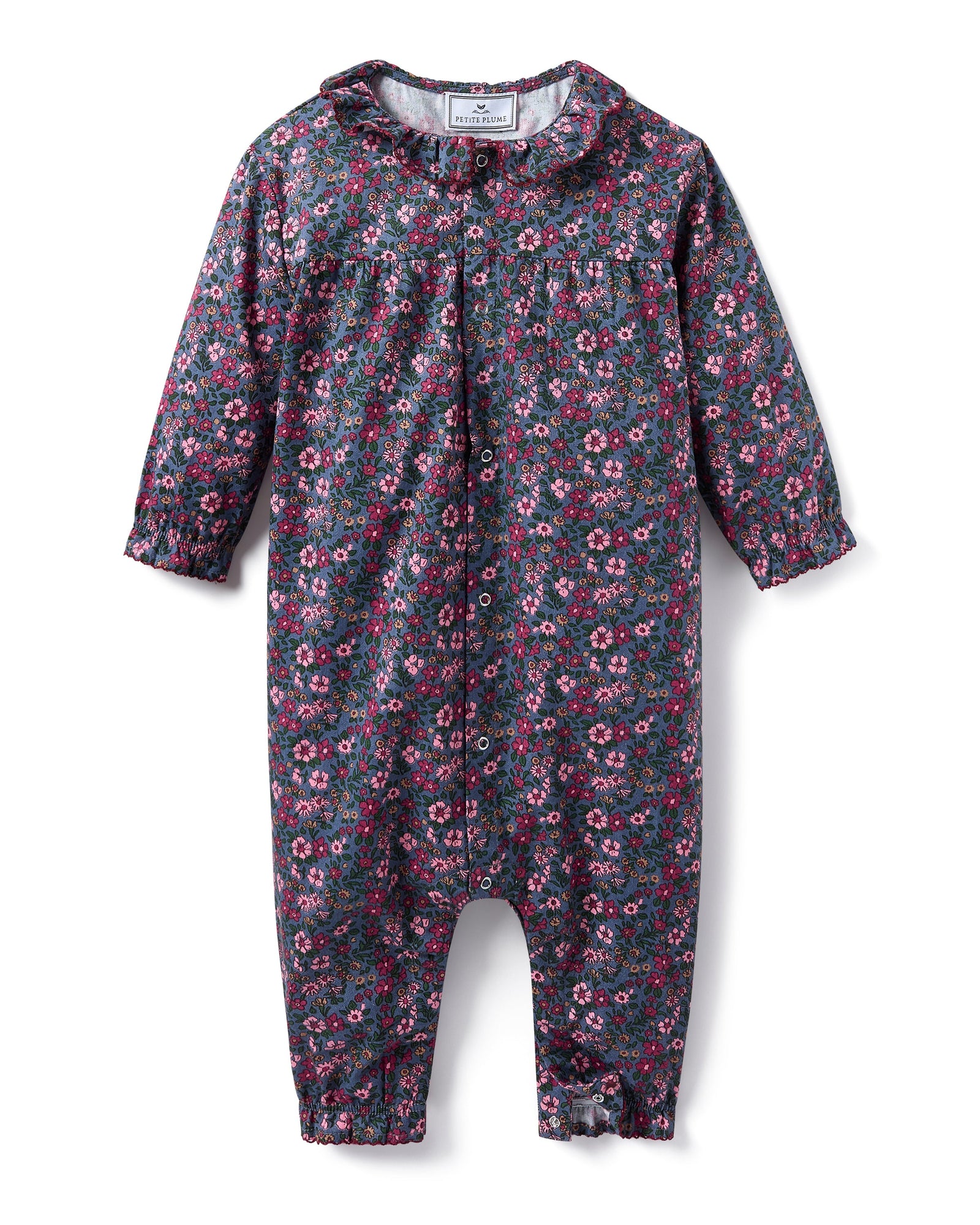 Baby's Twill Madeline Romper in Fleurs de Saison features long sleeves, a dark base with pink and purple floral print, front snap closures, a rounded collar, and gathered cuffs at wrists and ankles.