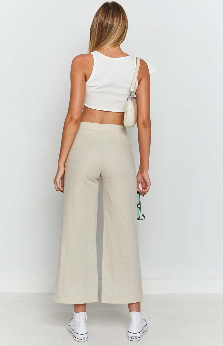 Beige linen blend pants with a natural slub texture and visible waistband seam