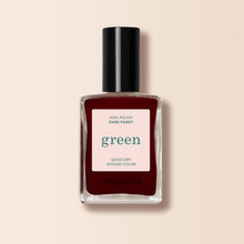 A bottle of Manucurist nail polish in the shade Dark Pansy, featuring a deep velvet red tone, black cap, and a Green™ range label on a beige background.