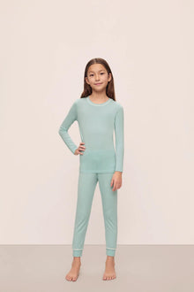 Model is wearing Kids Tencel Modal Unisex Long Pj Set in Canal Blue/Ivory