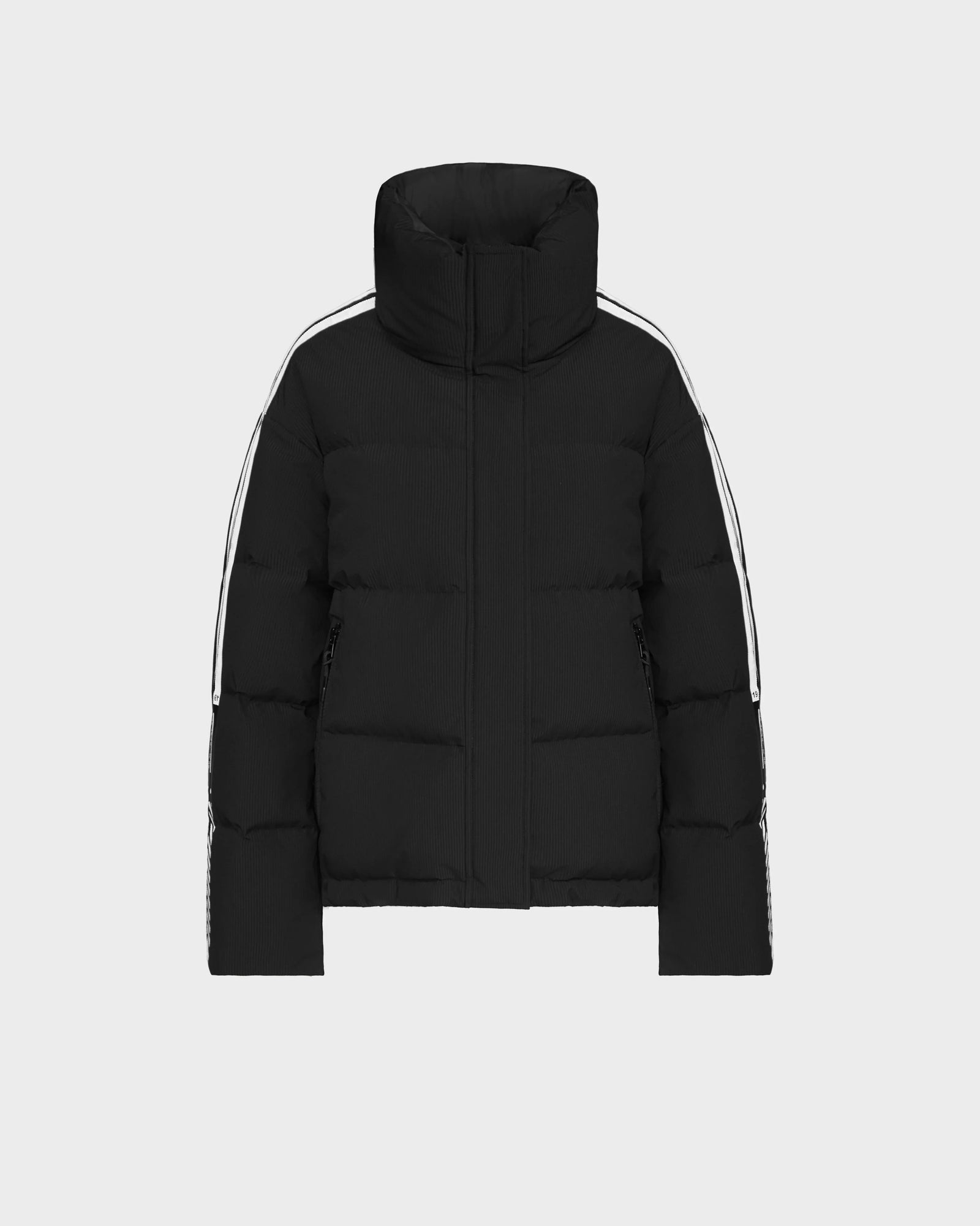The Rudsak KIMIA - 8124716 Black women's ski jacket features a high collar and bold white sleeve stripes, blending classic puffer style with modern details for sleek cold-weather comfort. Shown on a plain light grey background.
