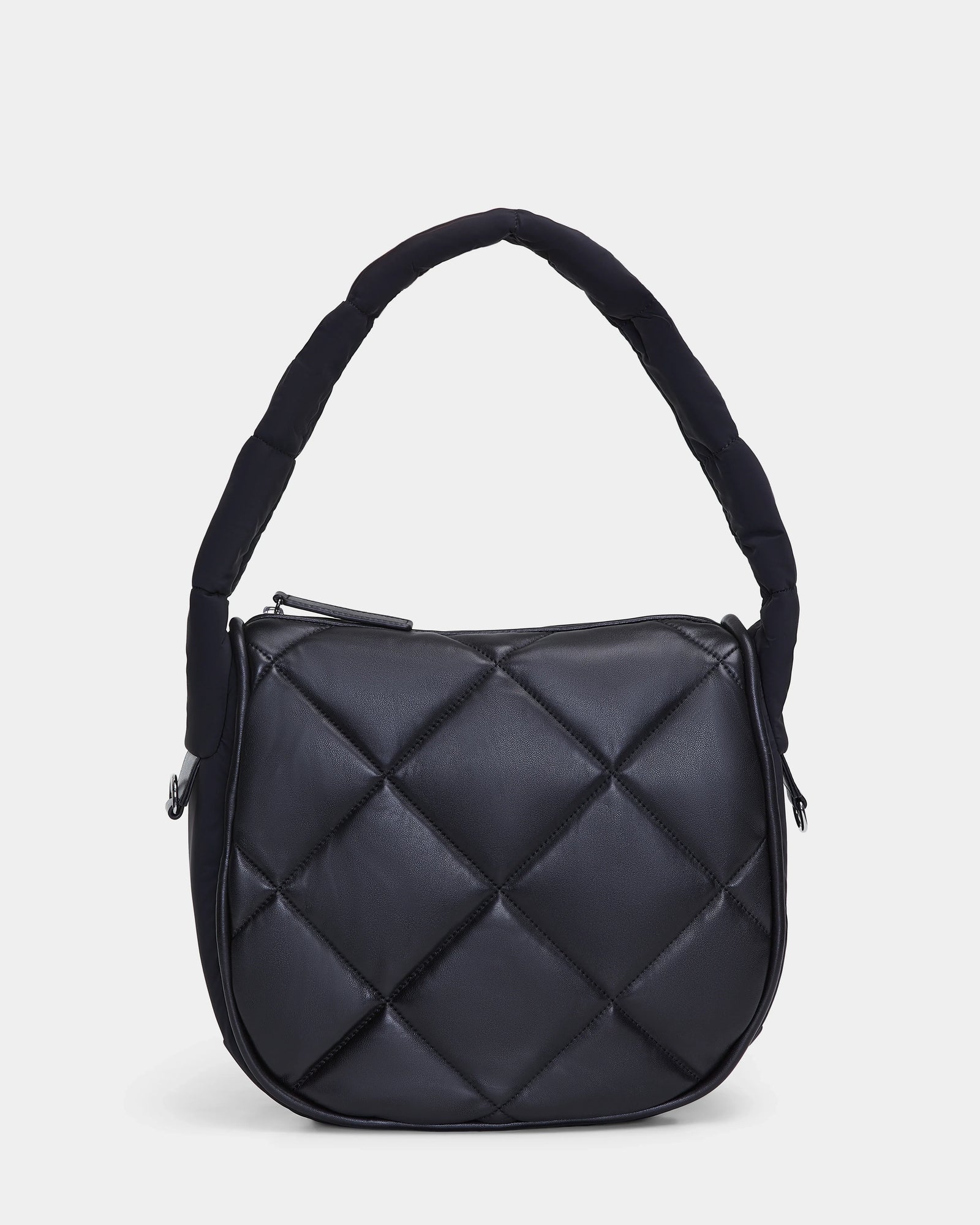 The NIOBE L - 8324503 Black by Rudsak is a black, quilted handbag with a rounded rectangular shape, thick padded handle, and bold diamond-shaped stitching. The product is photographed against a plain white background.