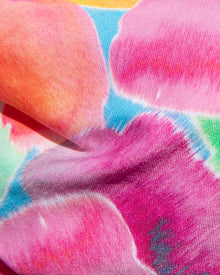 Close-up of colorful  fabric with pink, orange, and blue hues.