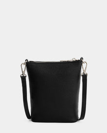 The Rudsak LILA - L325513 Black is a small women's crossbody bag in pebbled leather with silver hardware and an adjustable, detachable strap, displayed against a white background.