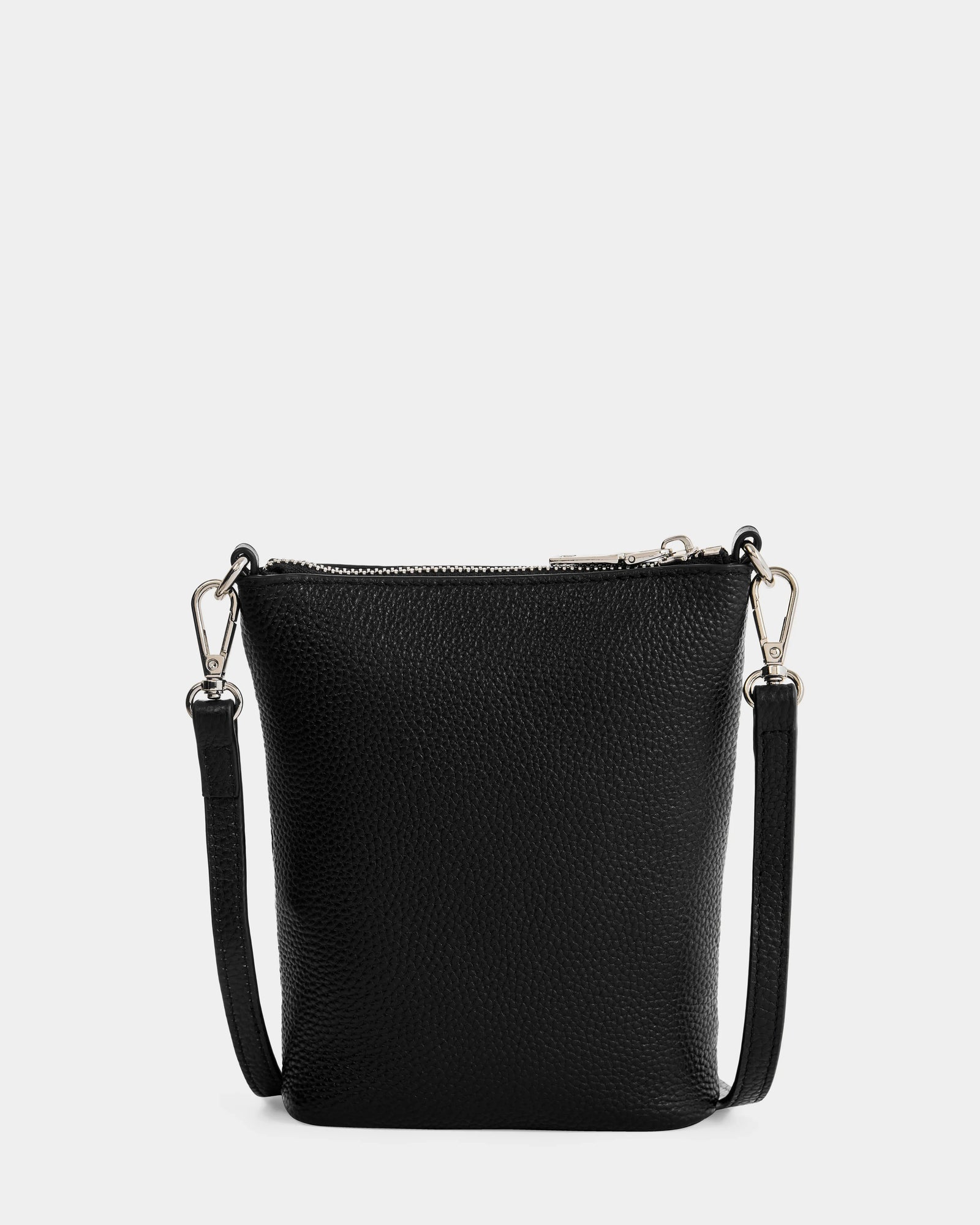 The Rudsak LILA - L325513 Black is a small women's crossbody bag in pebbled leather with silver hardware and an adjustable, detachable strap, displayed against a white background.