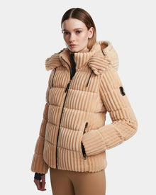 A woman wearing the MIRRY FF - L124507 Iceland beige ribbed short down puffer jacket by Rudsak, featuring a hood and zipped pockets, stands against a plain white background, looking slightly to the side with a neutral expression.