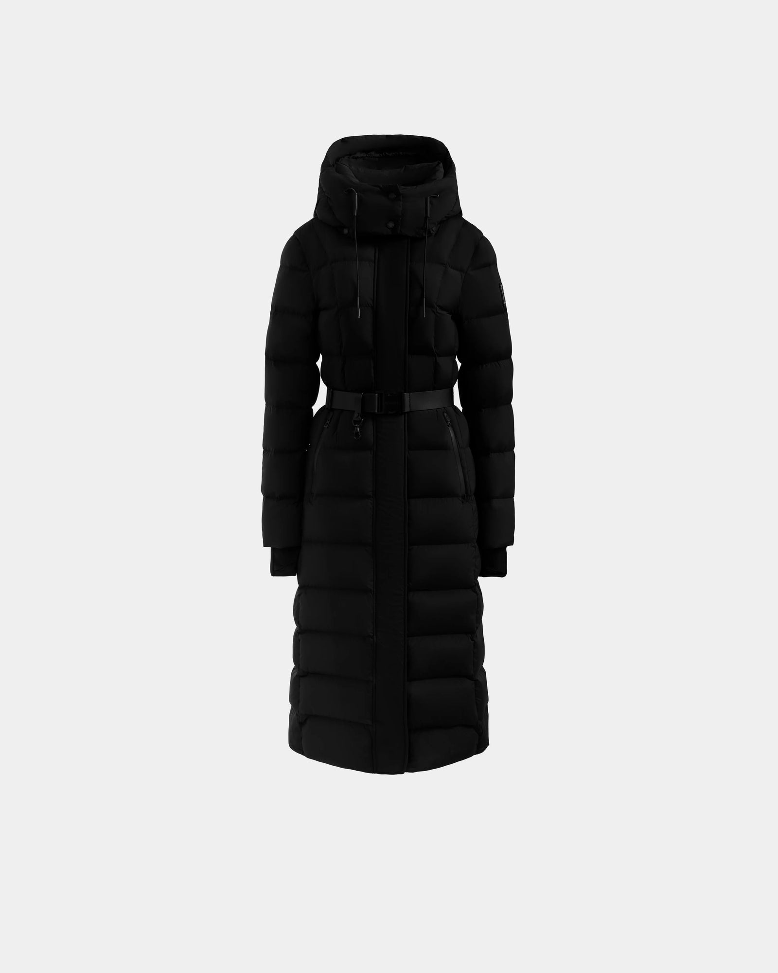 The Rudsak FRIDA M-L - L125608 Black is a women’s long down puffer coat with a detachable hood, front zipper, and waist belt, shown on a plain light gray background.