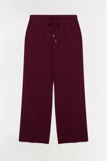 Deep burgundy knit pants with drawstring waist and ribbed cuffs.
