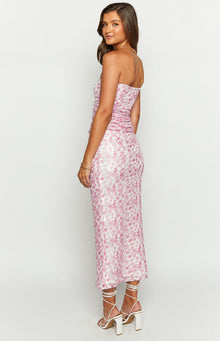 Side view of a pink floral print strapless maxi dress with ruched bodice and fitted silhouette