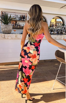 Close-up of the twisted bodice and front cutout with ruched detail on a black floral midi dress