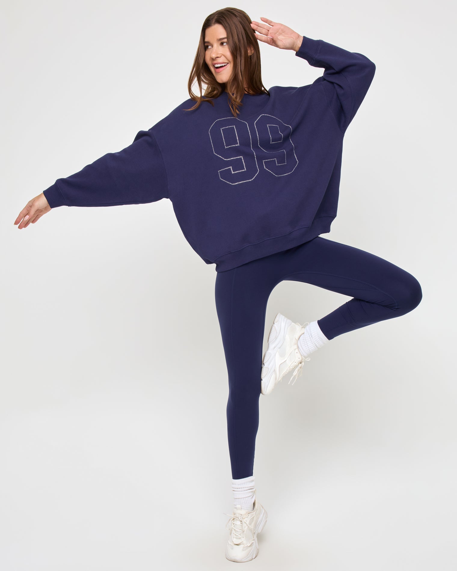 Side view of the LSPACE Legend Sweatshirt in midnight blue on a model against a light background, showing the cropped silhouette of the oversized sweatshirt.