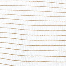 Close-up of fabric with thin gold lines on a white background