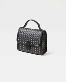Front view of the Amelia Bag in black showing the woven raffia texture and flap closure.
